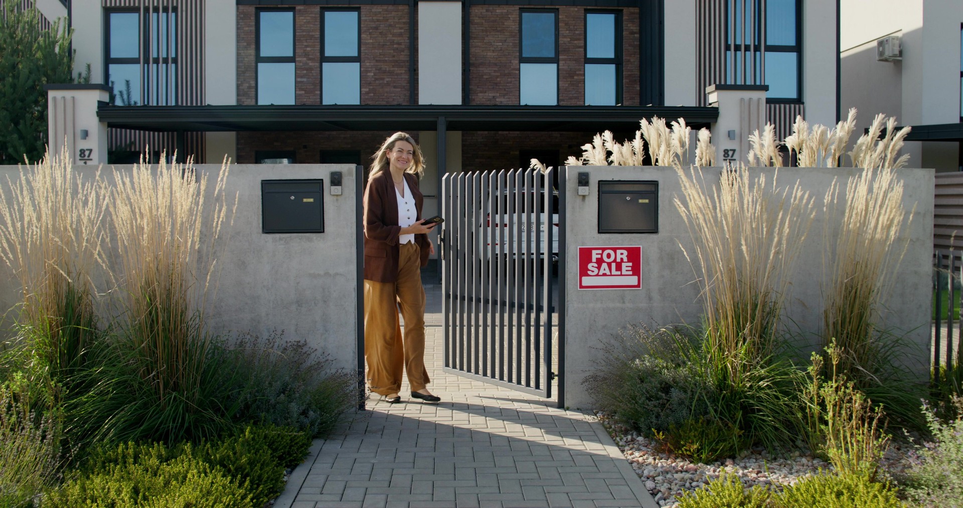 A real estate agent greets clients